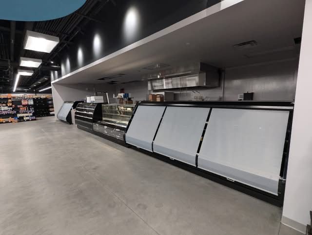 Long run of refrigerated deli cases in a new store